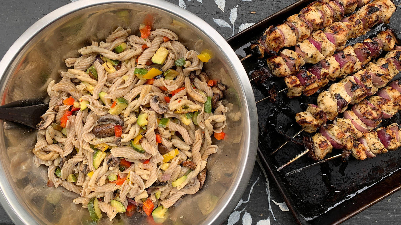 Photo of Foggy Mountain Pasta mixed with vegetables on the grill with chicken kebabs